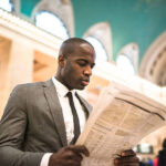 business man portrait reading news